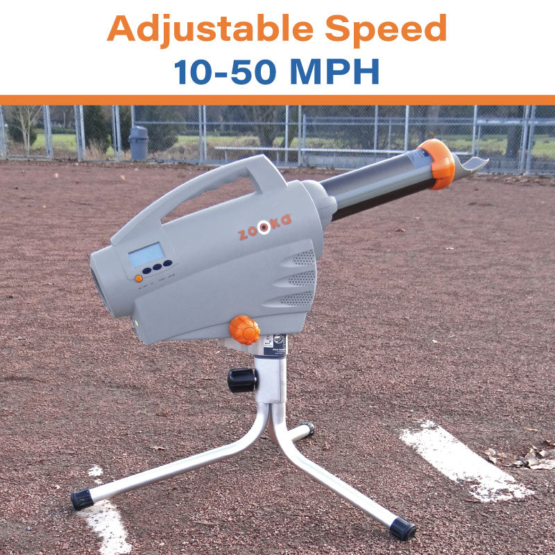 Zooka Baseball pitching machine on a field with adjustable speed display.